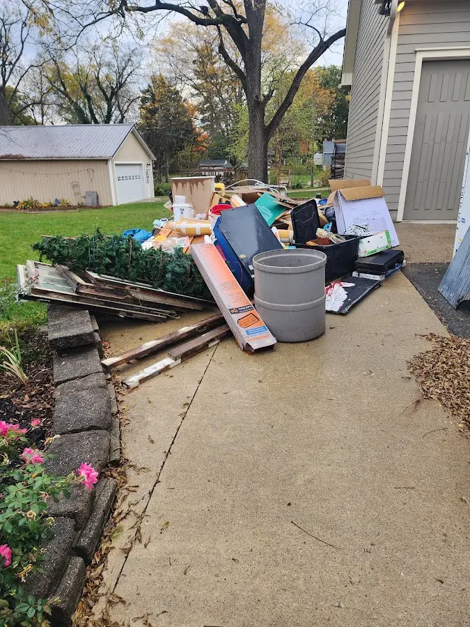 Dumpster being loaded with debris for Commercial Dumpster Rental in Lakehills